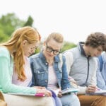 University students studying together in park